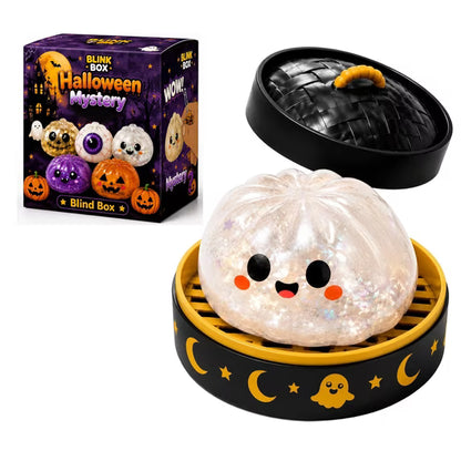 A cute, glittery Halloween Bun Squishy Toy from Okie Soft Play, with a smiling face, sits in a steamer basket next to a Halloween-themed blind box featuring more Filled TPR Fidget Characters and festive dumpling decorations.