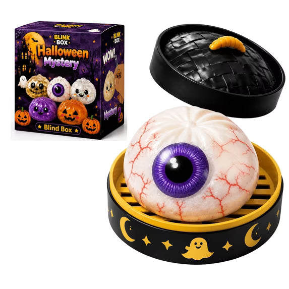 A Halloween Bun Squishy Toy – Filled TPR Fidget Character from Okie Soft Play, featuring a toy eyeball with a purple iris, sits in a round black and yellow container decorated with moon and ghost designs; packaging in the background reads BLINK BOX Halloween Mystery Blind Box and displays additional Halloween-themed squishy toy designs.