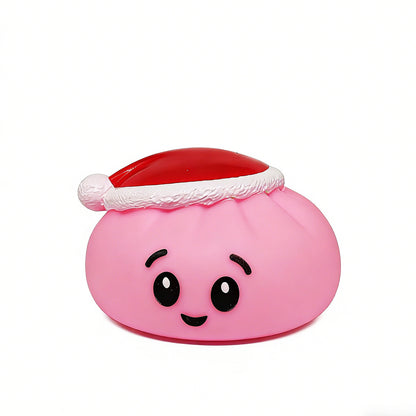 A festive, pink, round Christmas Bun Squeaky Toy by Okie Soft Play—featuring big eyes, a smiling mouth, and a cheerful red-and-white Santa hat—sits against a plain white background, making it an adorable choice for SEO-friendly holiday graphics or Christmas-themed designs.