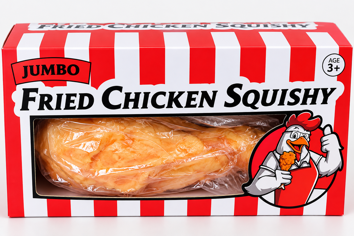 A boxed toy labeled “Giant Chicken Leg Squishy – Extra-Large TPR Flour-Filled Stress Toy” by Okie Soft Play, featuring packaging with a cartoon chicken eating fried chicken and suitable for ages 3 and up. The toy inside resembles a piece of fried chicken.
