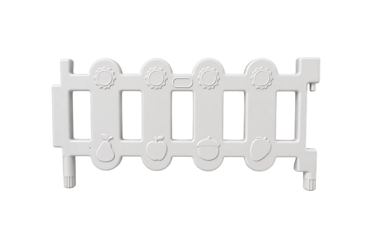 A white plastic Okie Soft Play Toddler Fence Panel, CPC Certified for safety, featuring vertical rectangular openings and embossed fruit and acorn designs along the bottom edge, shown on a plain white background.